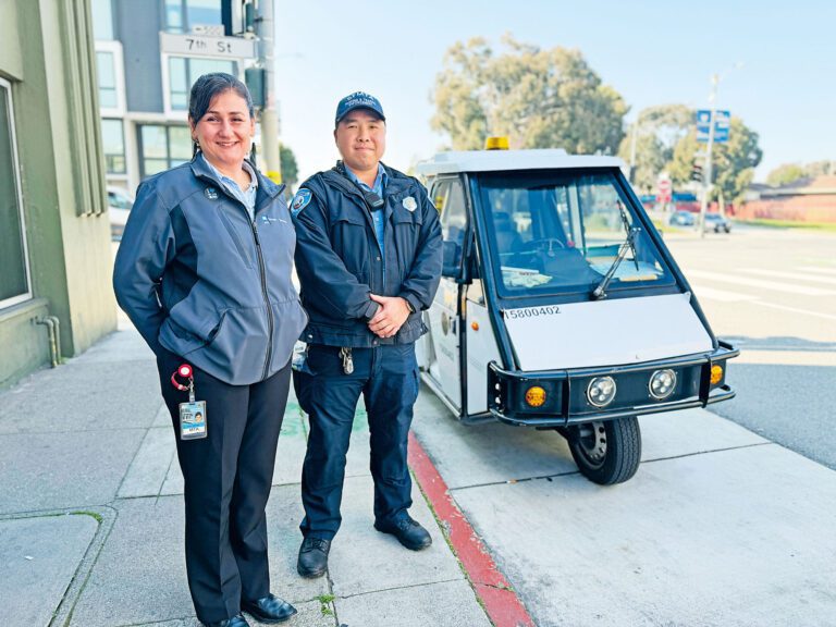 三藩市交通局街道管理部門總監韋愛思（左）與前線交通管控員黃偉棠（右）於超級碗活動前在市中心執勤，配合道路封閉及人流管制安排。記者蘇婕雅攝